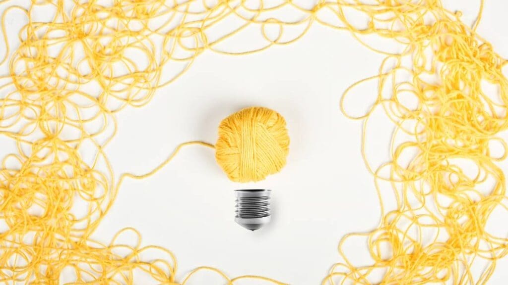 Yellow yarn forming the shape of a light bulb
